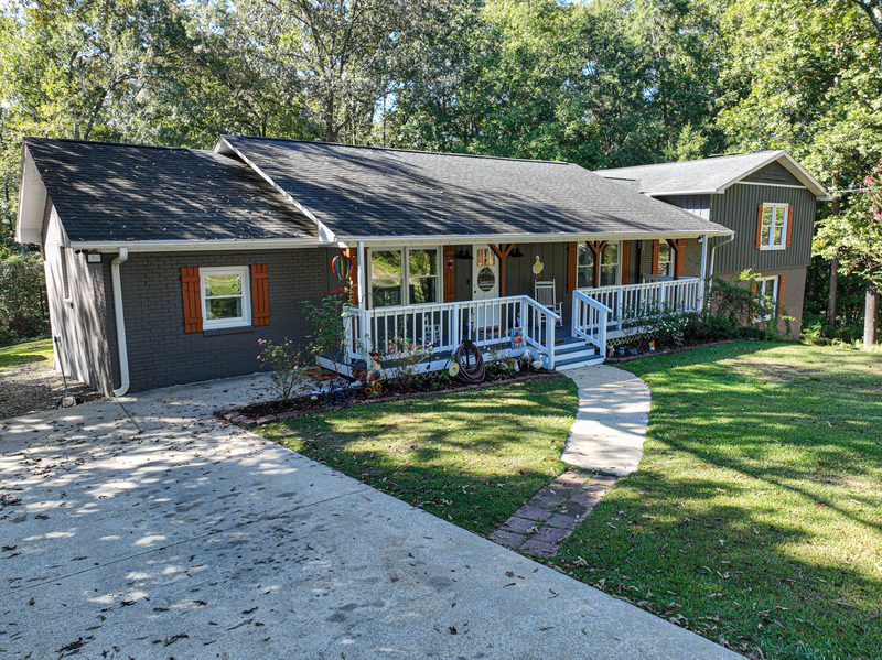 Brick ranch house in Centreville Alabama with a covered front porch and a walkway across the lawn