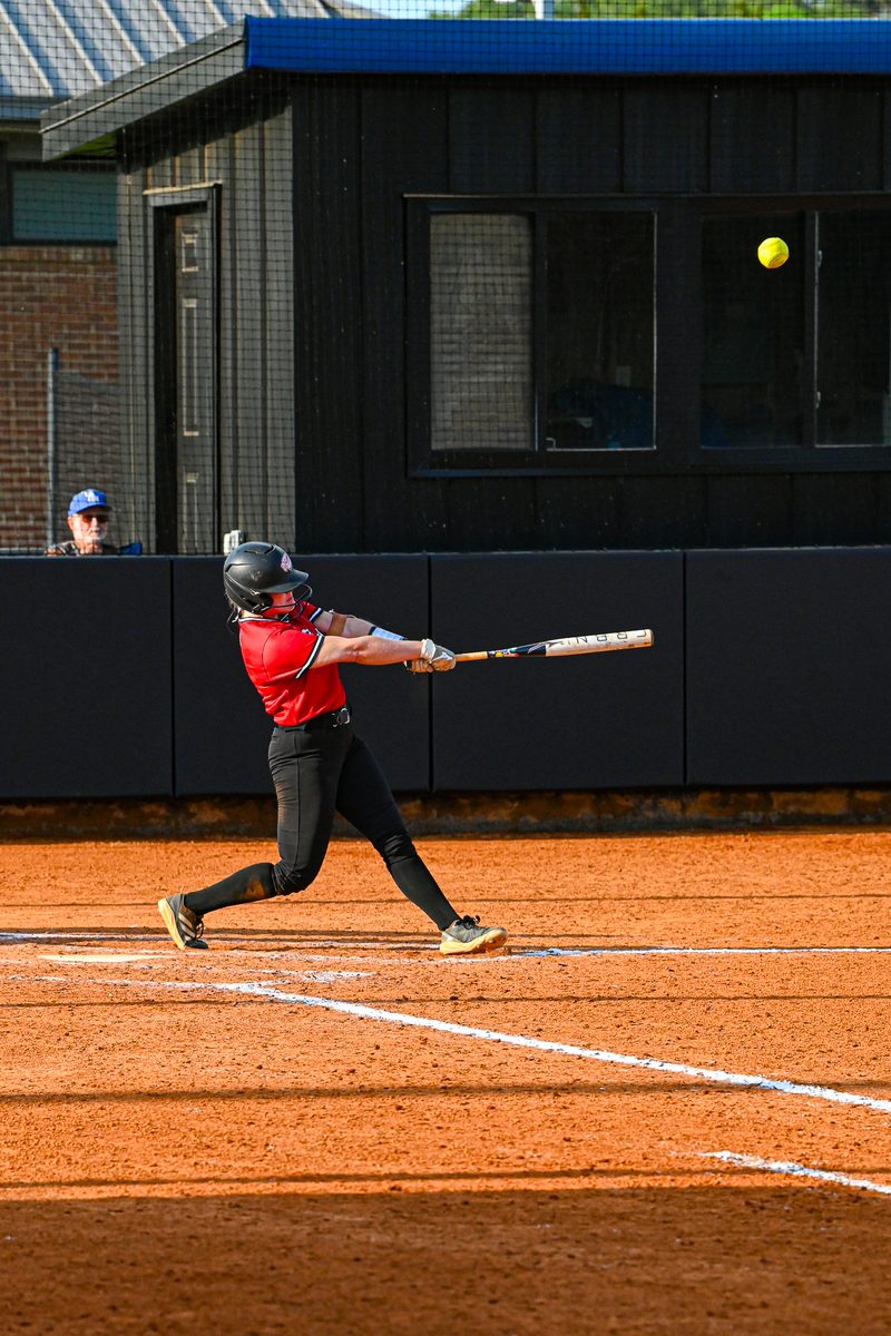 West Alabama softball player swinging at a pitch during a home game
