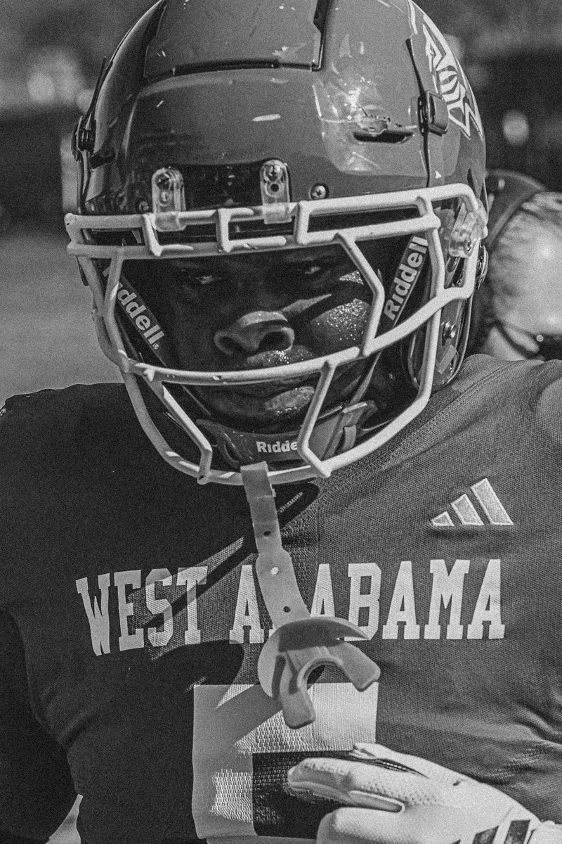 Black and white close up of a West Alabama football helmet and facemask
