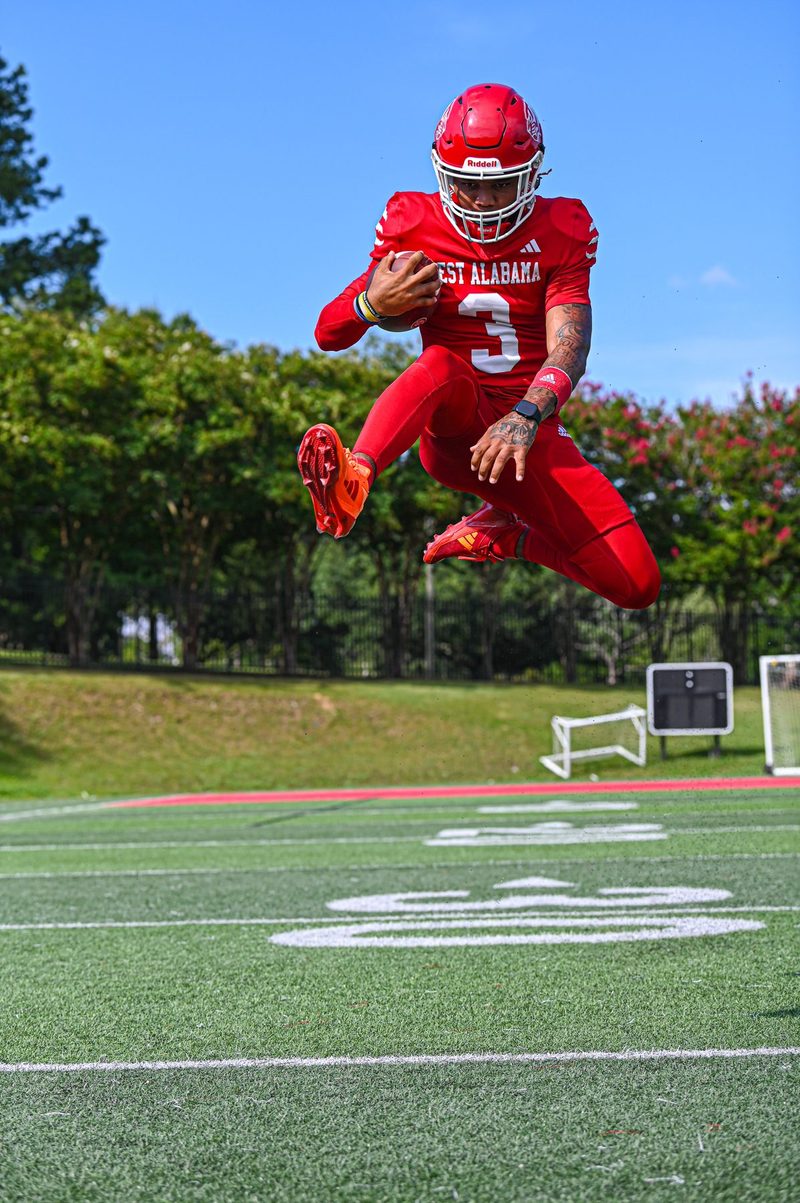 West Alabama player number 3 leaping in the air on a practice field